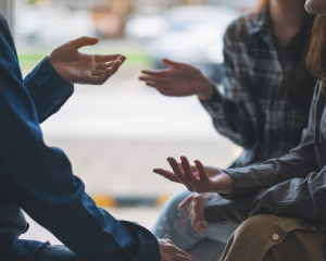 Menschen sitzen im Kreis und unterhalten sich